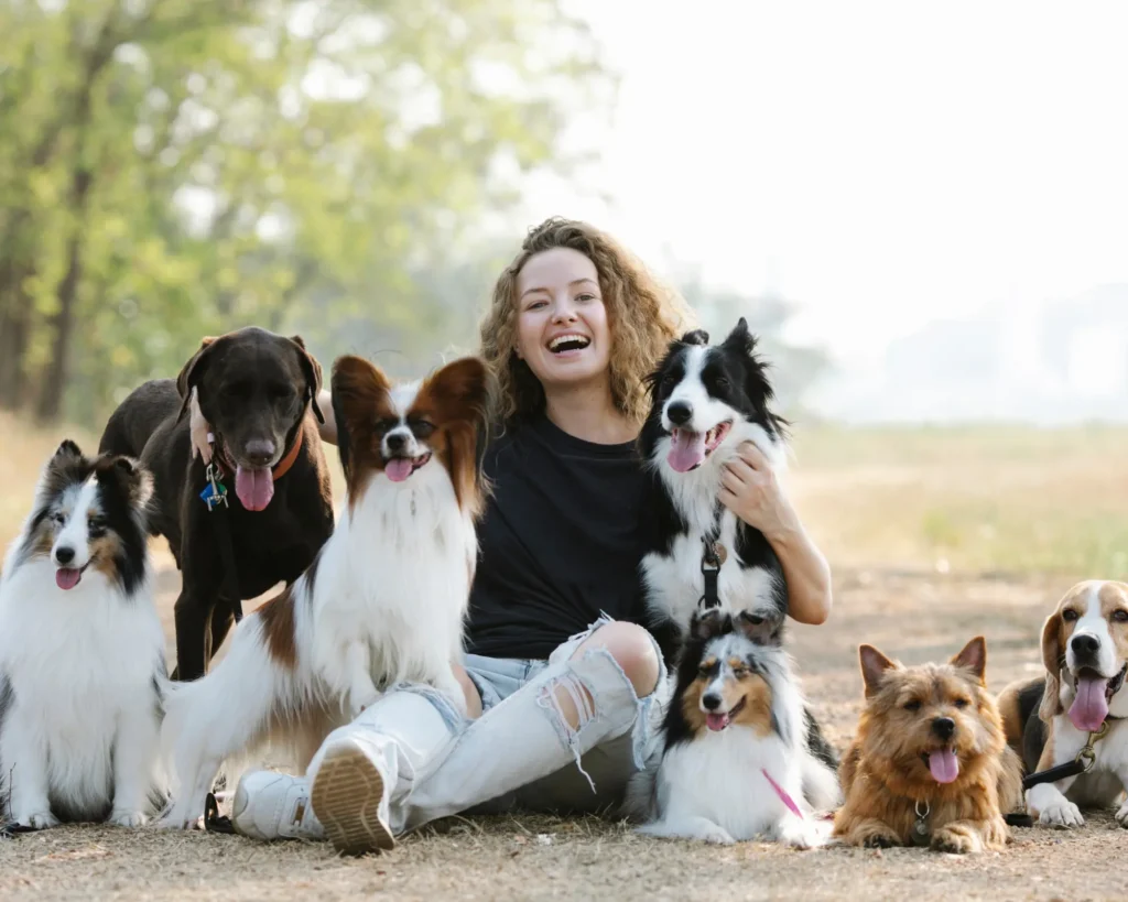 a woman surrounded by many pets bringing pet dogs and cats to the european union purrfect pilots